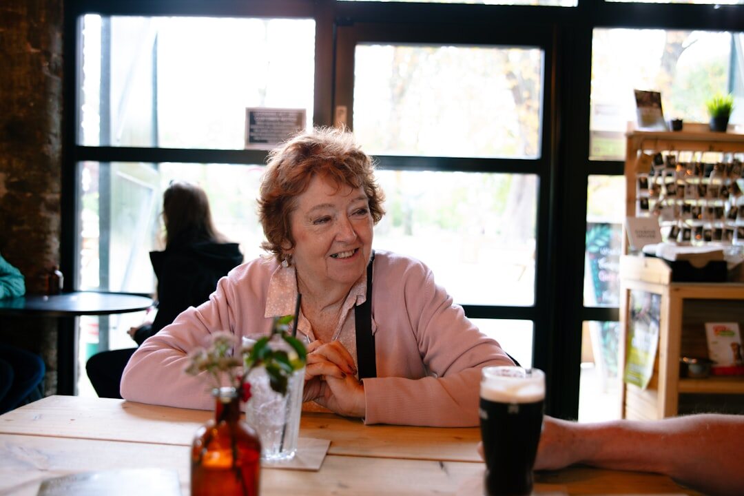 Senior friends chatting over coffee at a cafe table